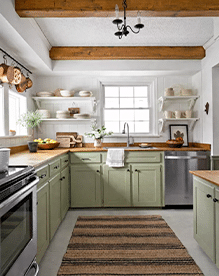 Farmhouse Kitchen with Sage Green Cabinets and Warm Natural Materials Farmhouse kitchen with sage green cabinets, wood countertops, open shelving, and natural light creating a warm and inviting neutral palette.