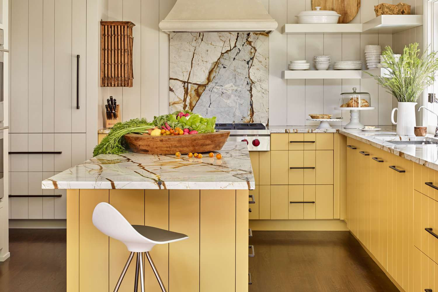 Warm Yellow Kitchen with Natural Wood and Soft Neutral Accents Warm kitchen with yellow cabinetry, natural wood island, and soft neutral accents creating a bright and inviting atmosphere.