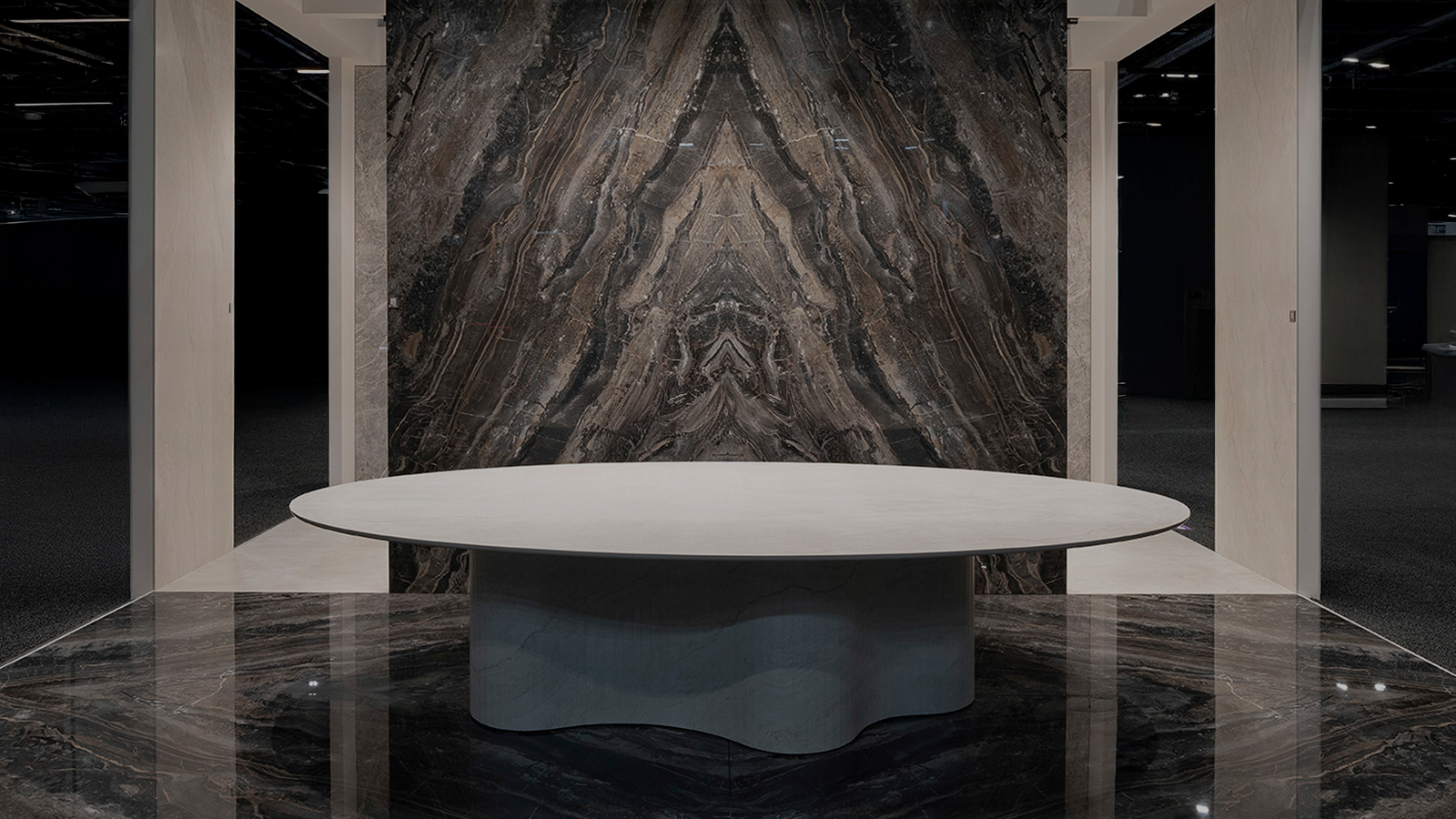 Optimum_Kbis_hero-DEF Desk entirely made of tile with a geometric pattern, showcased at Coverings 2026, demonstrating tile as a structural material in furniture design